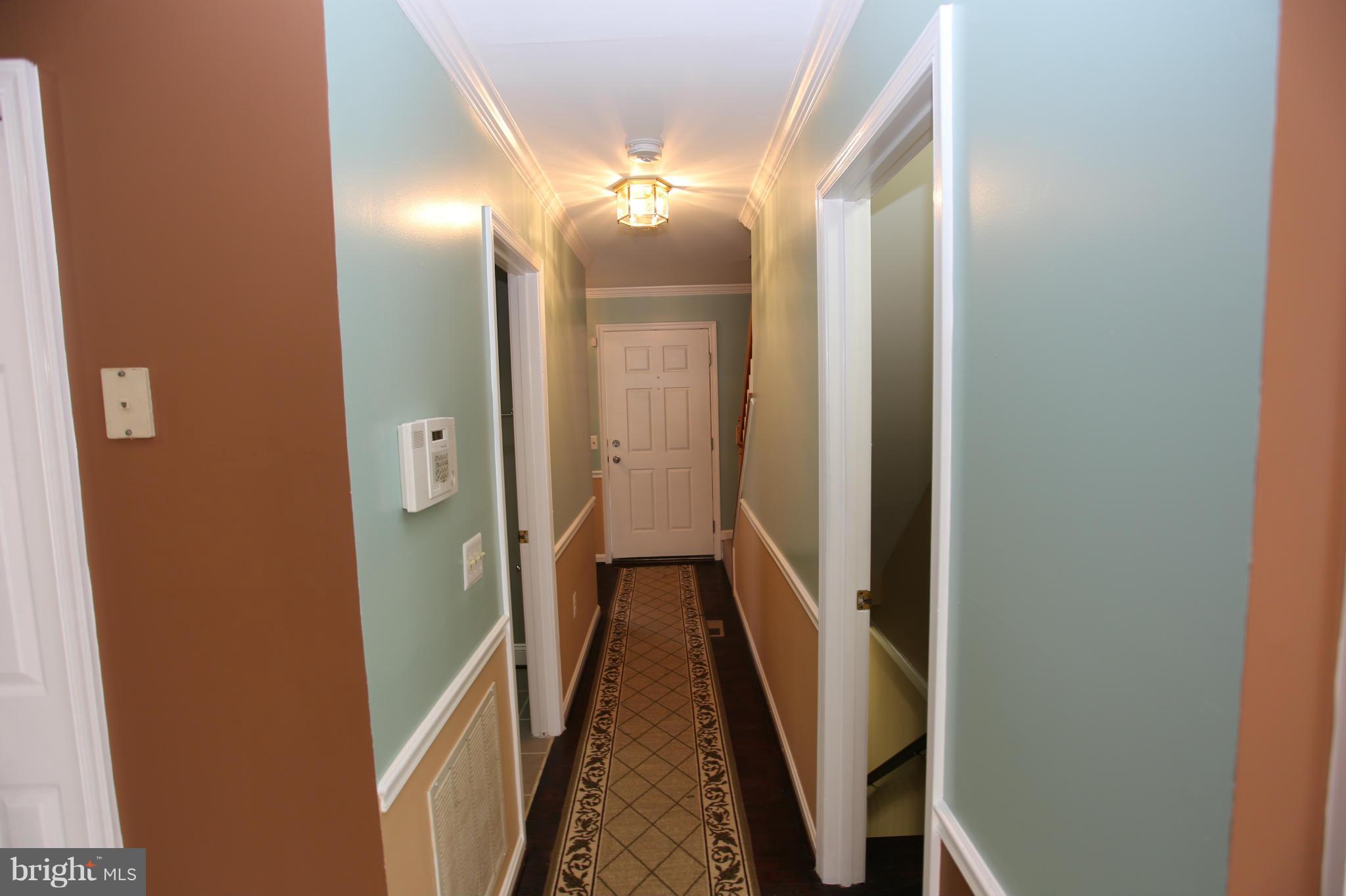703 Monarch Ridge Road Frederick, MD 21703 - Photo 13 of 30 a view of a hallway with wooden floor and staircase