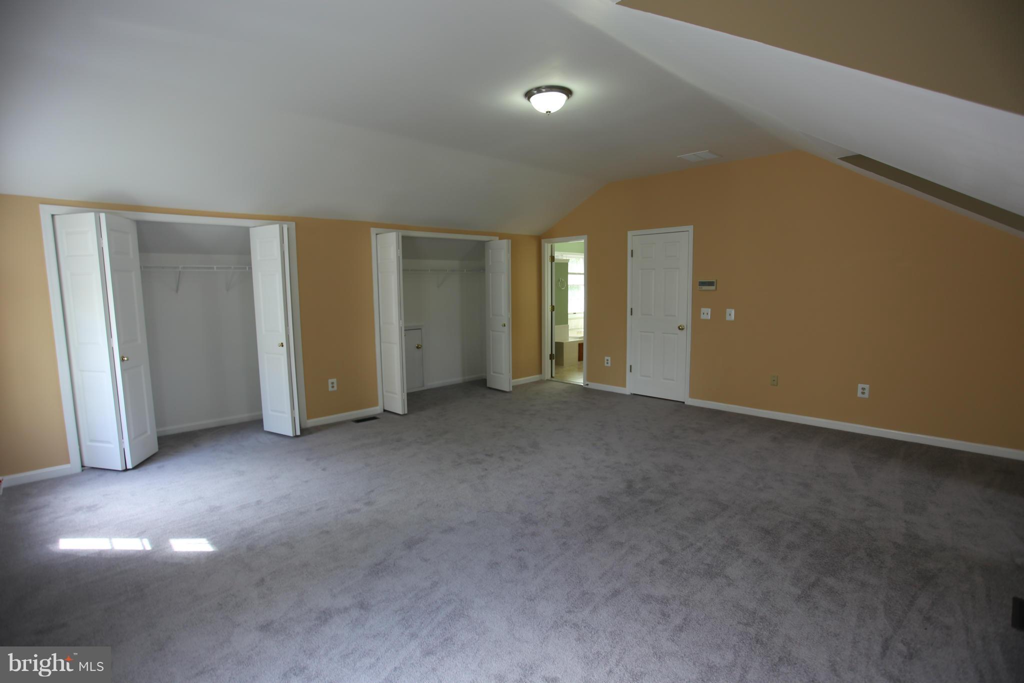 703 Monarch Ridge Road Frederick, MD 21703 - Photo 15 of 30 an empty room with closet and mirrors