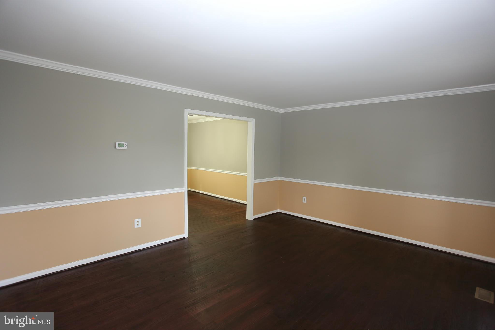 703 Monarch Ridge Road Frederick, MD 21703 - Photo 4 of 30 an empty room with wooden floor and windows