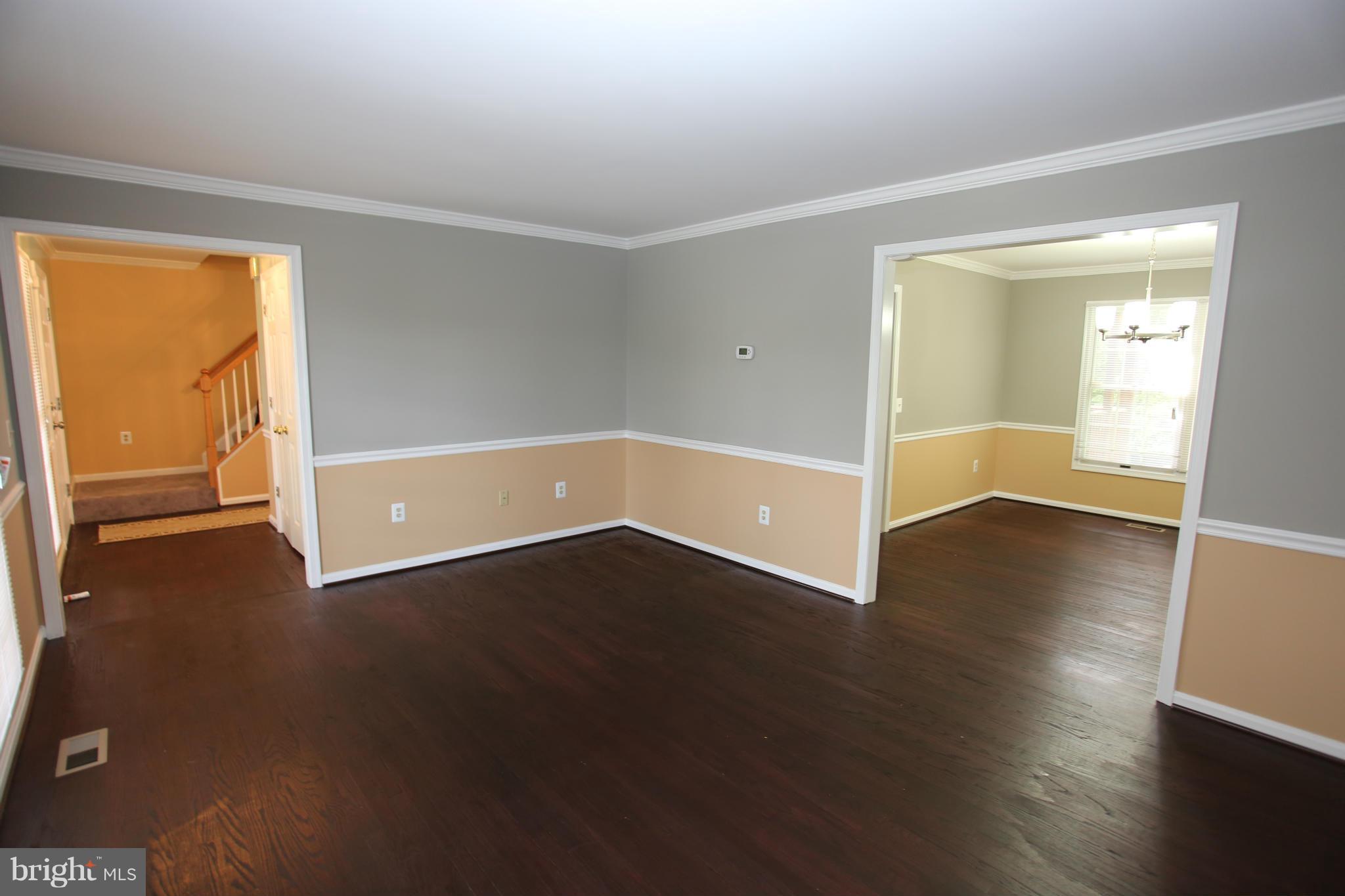 703 Monarch Ridge Road Frederick, MD 21703 - Photo 5 of 30 an empty room with wooden floor and windows