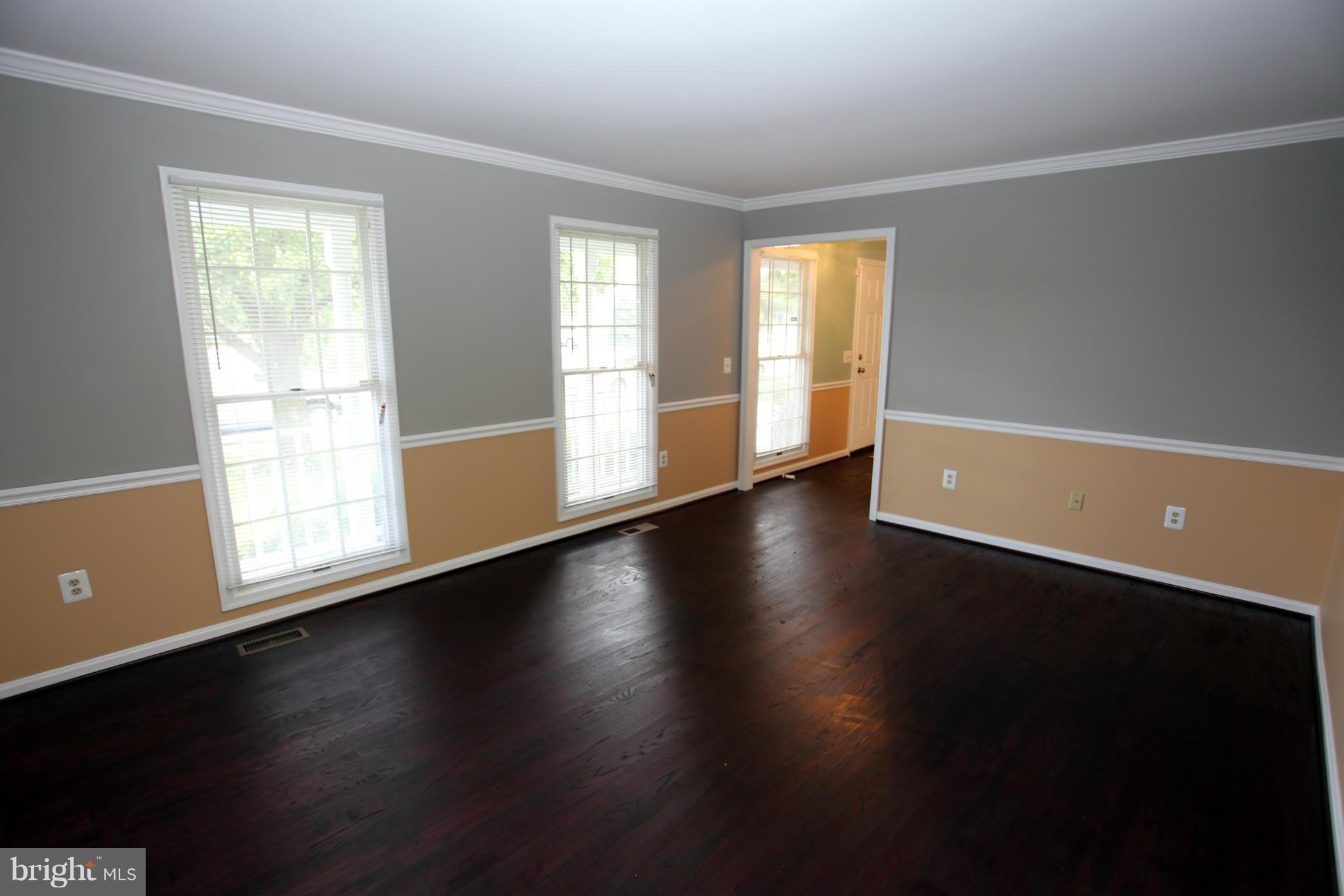 703 Monarch Ridge Road Frederick, MD 21703 - Photo 6 of 30 a view of a livingroom with wooden floor and a window