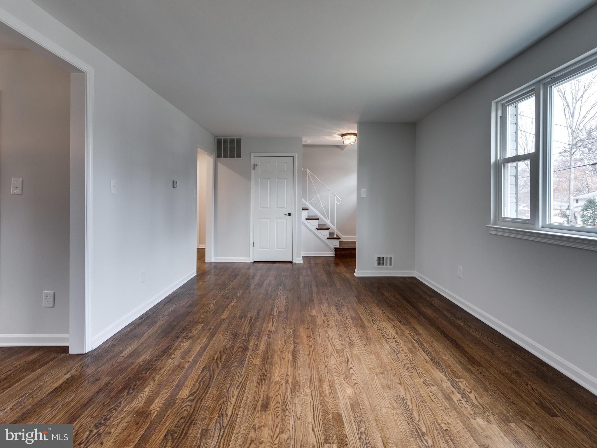 8918 Victoria Road Springfield, VA 22151 - Photo 3 of 30 a view of empty room with wooden floor and fan
