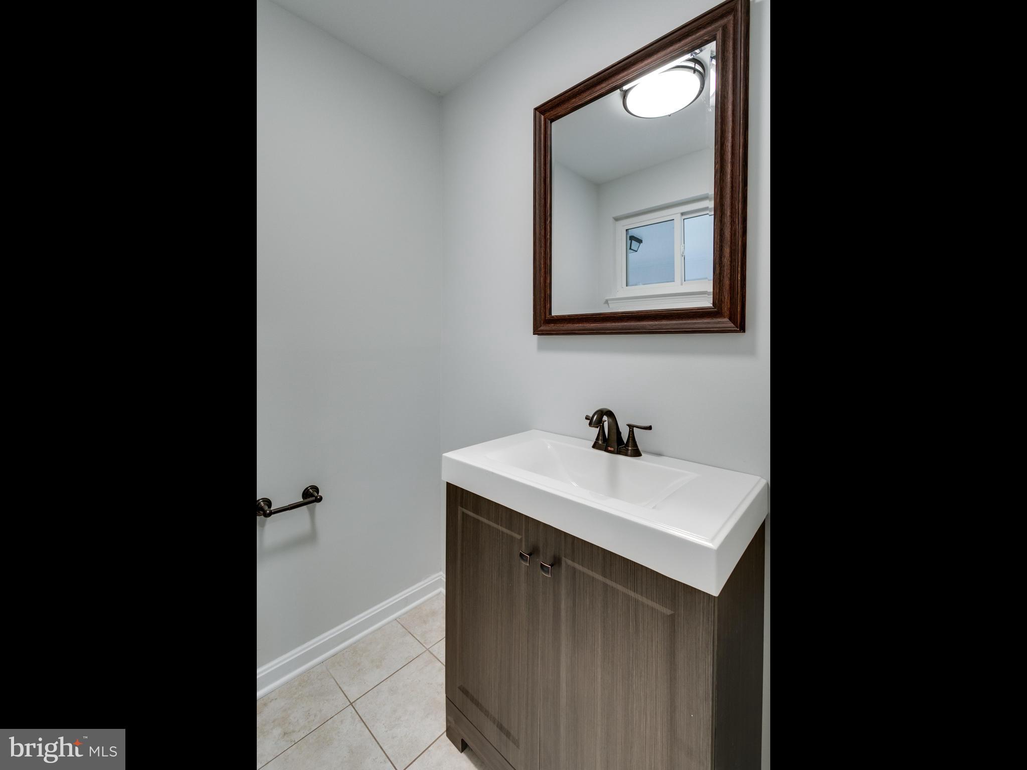 8918 Victoria Road Springfield, VA 22151 - Photo 5 of 30 a bathroom with a sink and a mirror