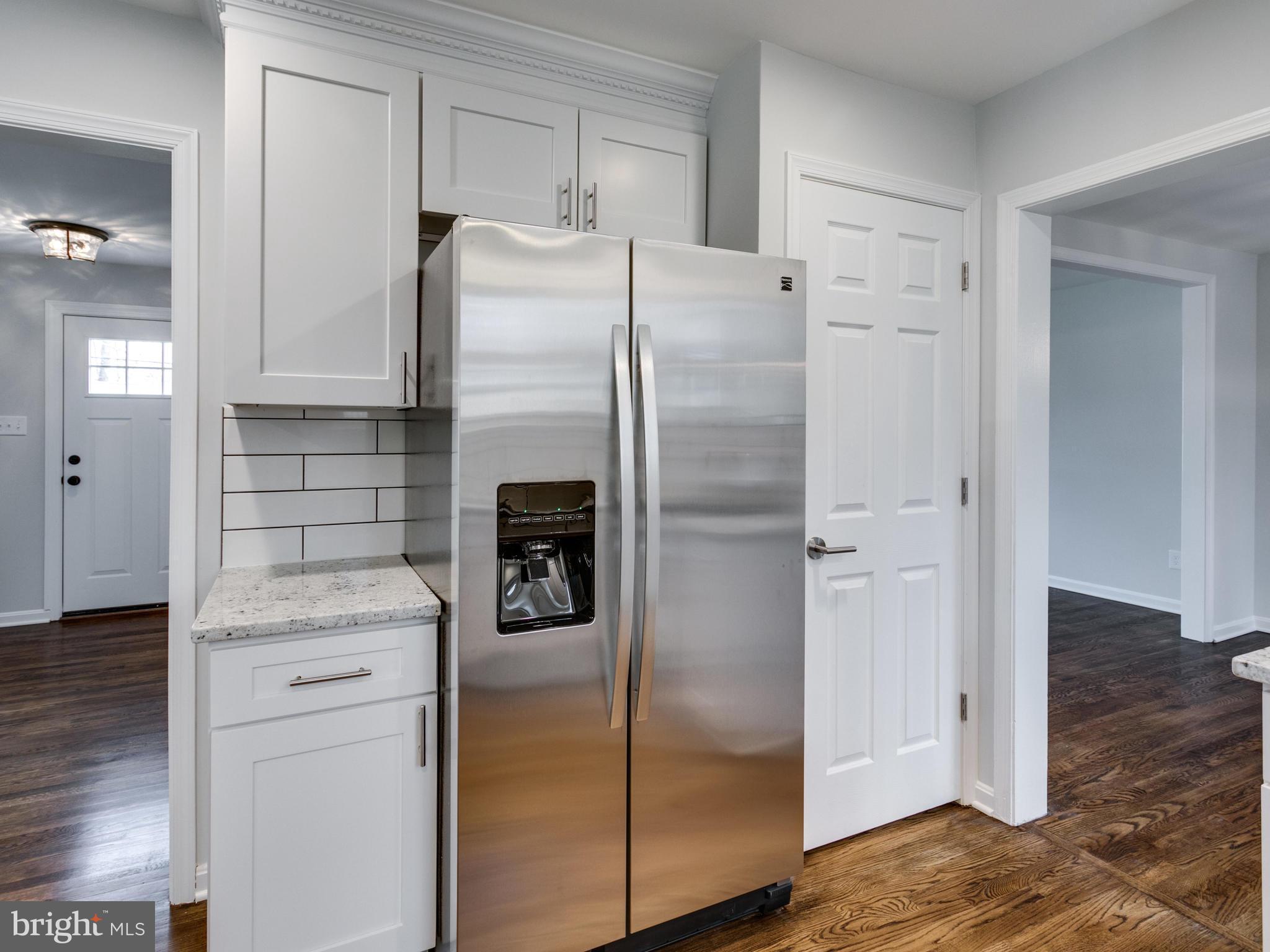 8918 Victoria Road Springfield, VA 22151 - Photo 9 of 30 a kitchen with a refrigerator sink and cabinets