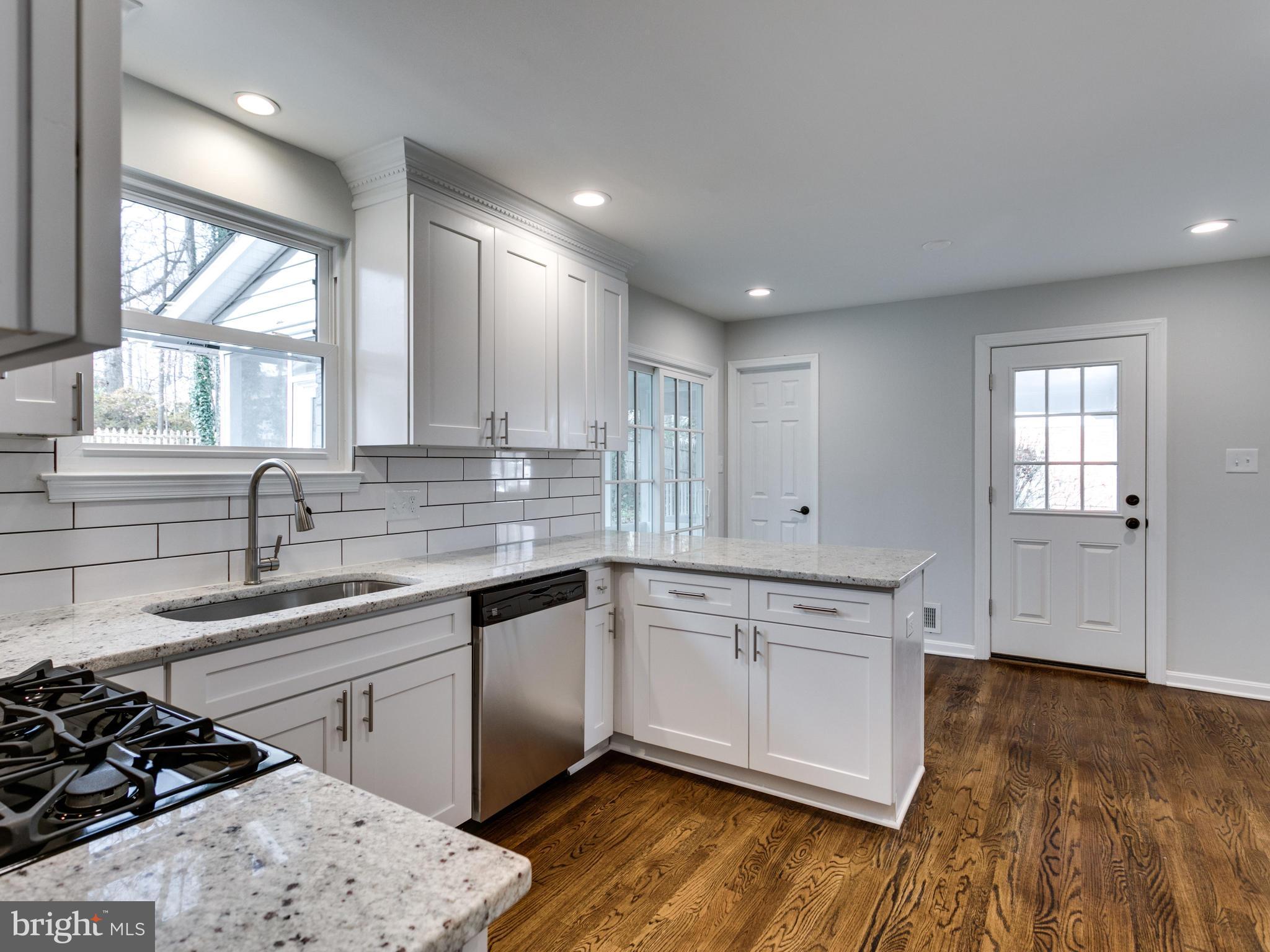 8918 Victoria Road Springfield, VA 22151 - Photo 10 of 30 a kitchen with a sink stove and cabinets
