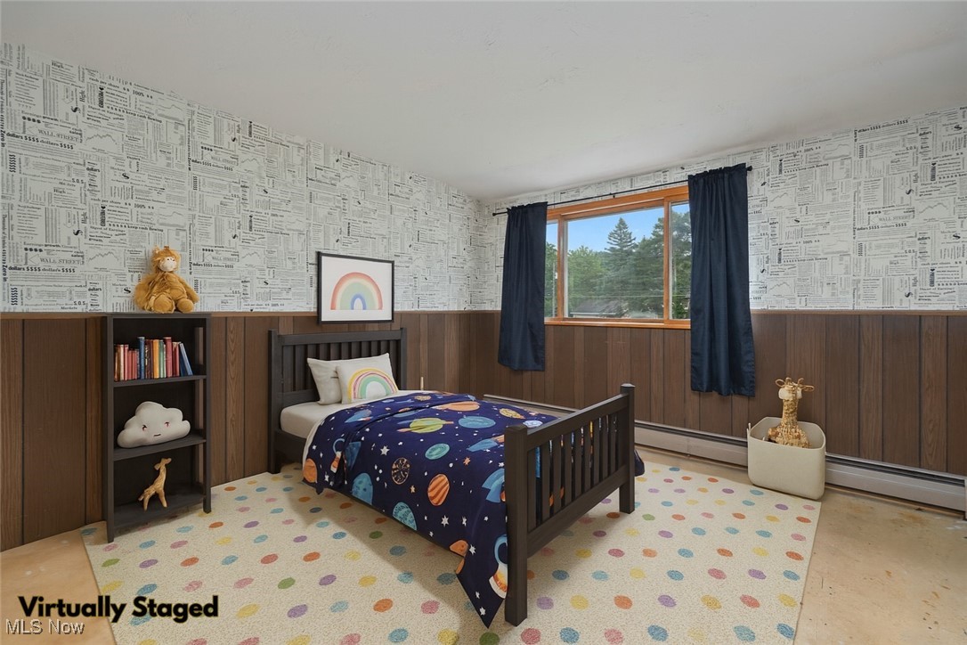 144 Substation Road Brunswick, OH 44212 - Photo 25 of 43 Bedroom featuring baseboard heating, wainscoting, wallpapered walls, and wood walls