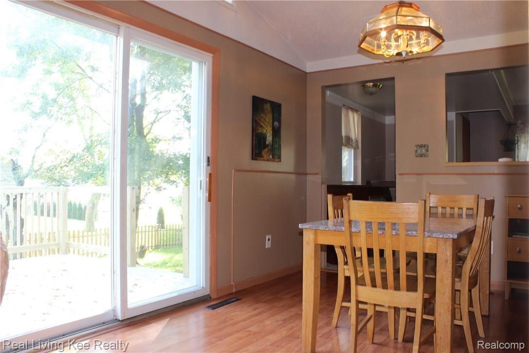 4620 Durham Road Utica, MI 48317 - Photo 12 of 38 The light filled dining room has a large door wall which leads directly to the brand new deck!