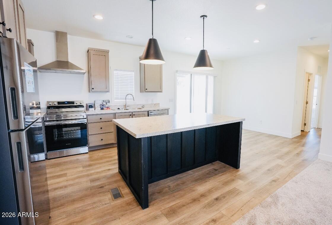 4710 Lazy Lariat Lane Rimrock, AZ 86335 - Photo 6 of 19 a kitchen with stainless steel appliances granite countertop a stove a sink dishwasher and a wooden cabinets