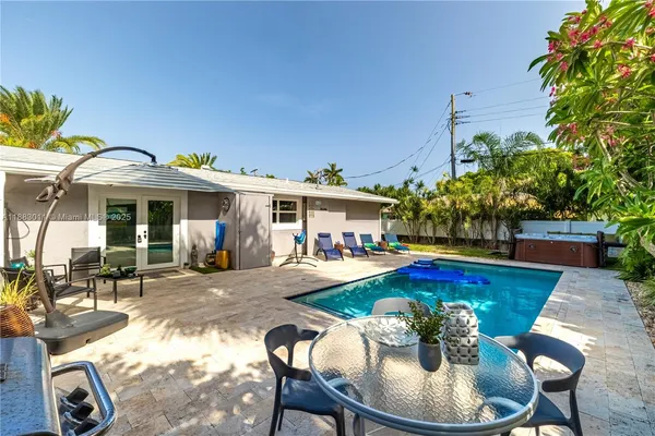 a view of a house with swimming pool and sitting area