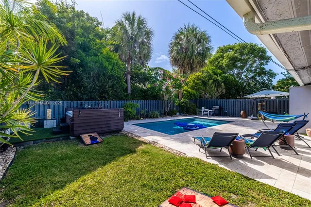 a view of a backyard with sitting area