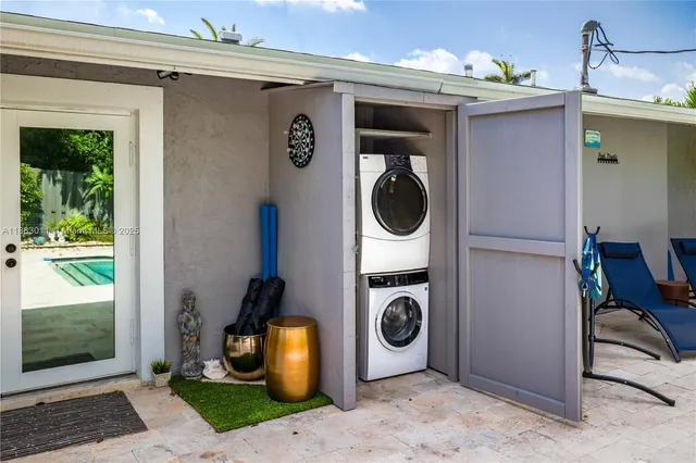 a view of a storage and utility room with a washer dryer