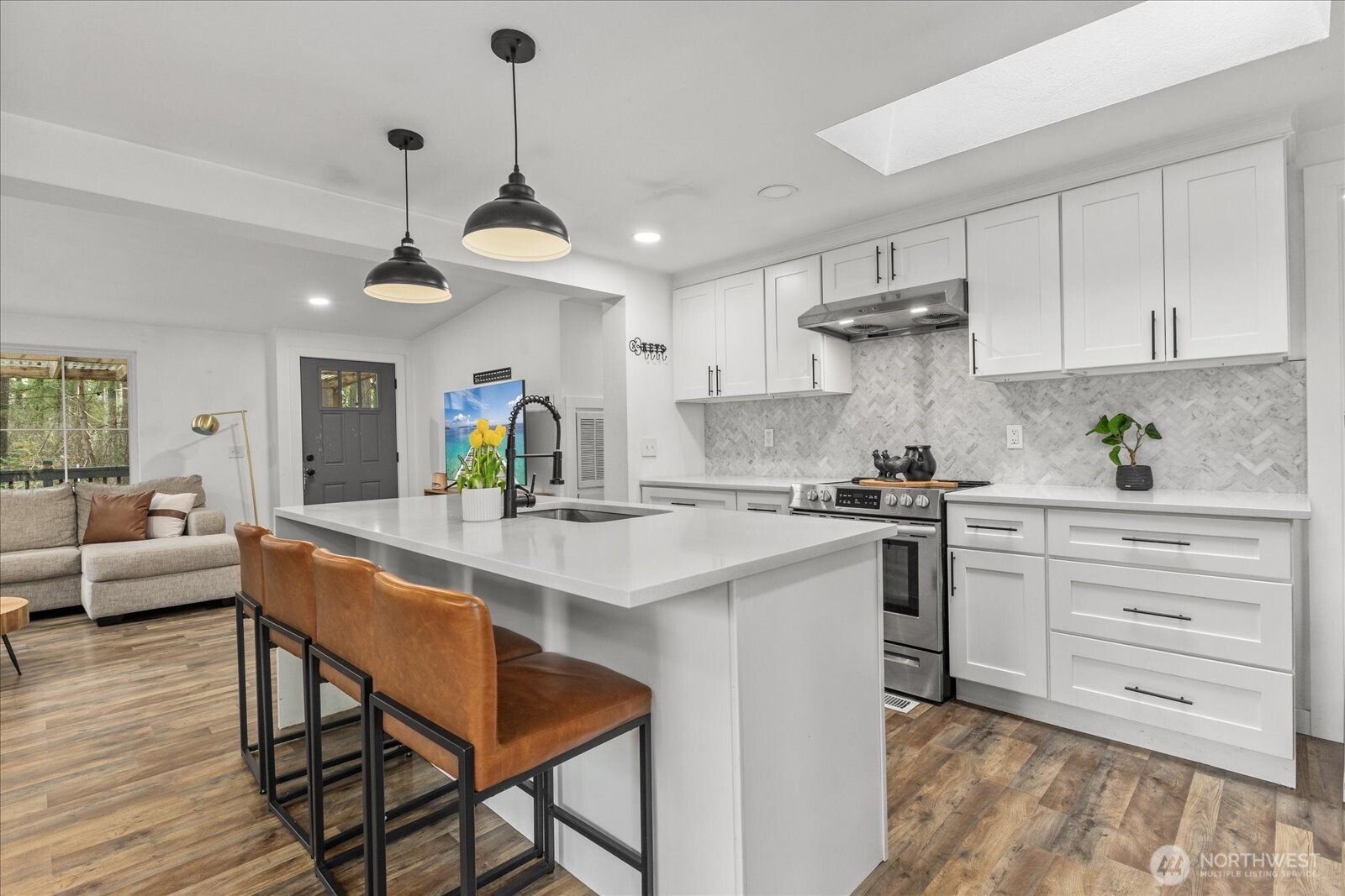 20609 Southeast 245th Place Maple Valley, WA 98038 - Photo 13 of 34 a kitchen with stainless steel appliances kitchen island granite countertop a table chairs and a refrigerator