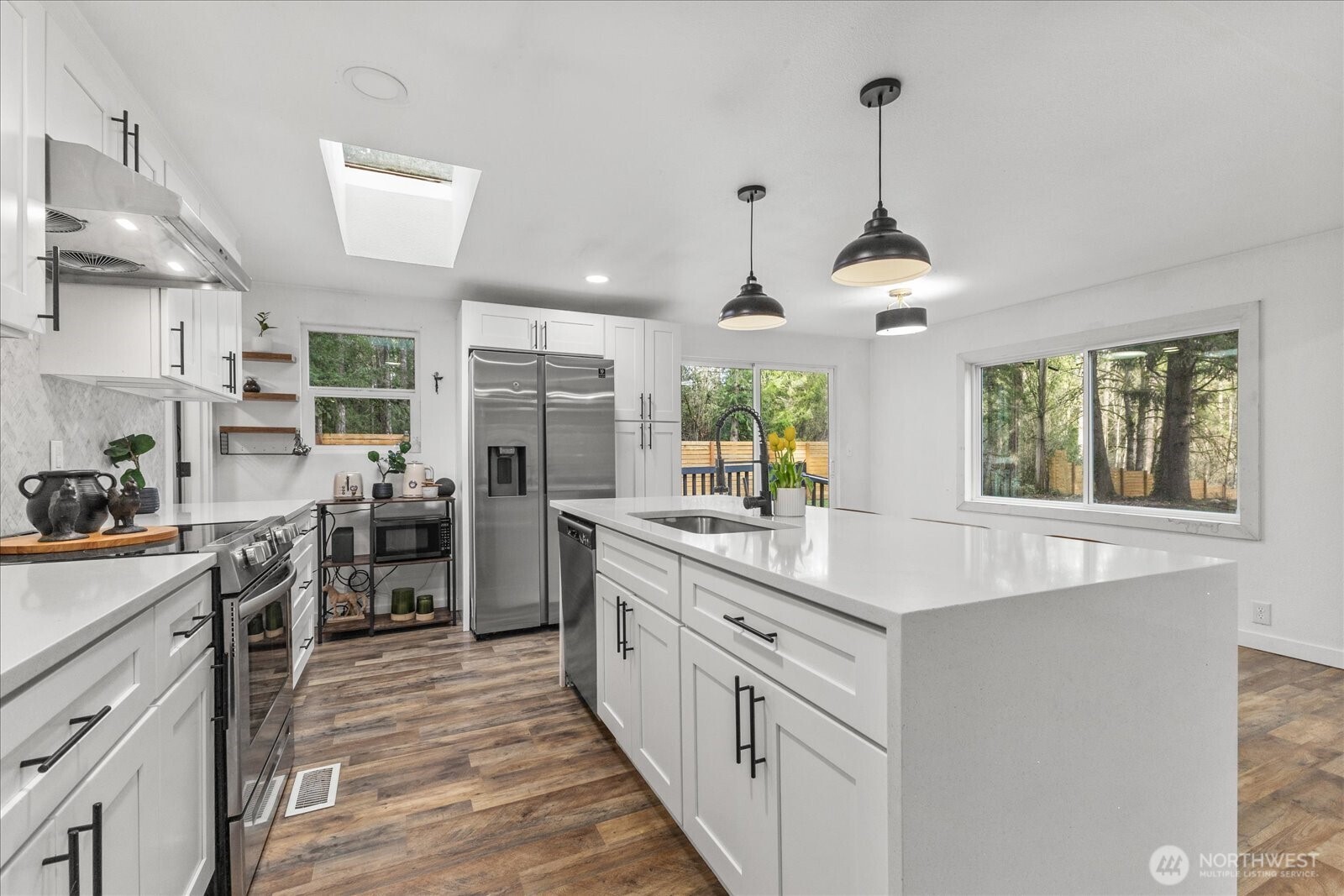 20609 Southeast 245th Place Maple Valley, WA 98038 - Photo 16 of 34 a kitchen with stainless steel appliances a sink stove and refrigerator