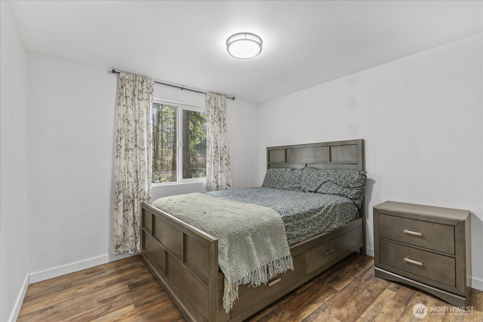 20609 Southeast 245th Place Maple Valley, WA 98038 - Photo 23 of 34 a bed sitting in a bedroom next to a window