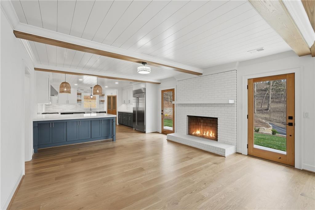 3454 Green Apple Road Gainesville, GA 30506 - Photo 21 of 115 a living room with stainless steel appliances kitchen island a fireplace wooden floor and a fireplace