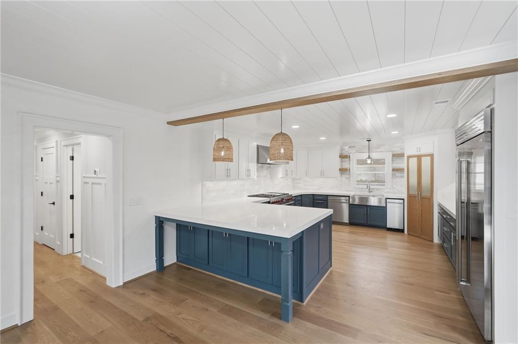 3454 Green Apple Road Gainesville, GA 30506 - Photo 27 of 115 a large kitchen with a large counter top a sink stainless steel appliances and cabinets