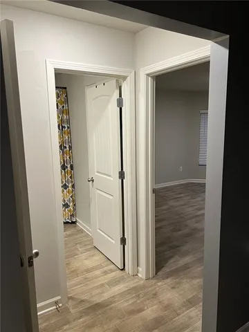 a view of a livingroom with wooden floor and stairs