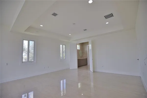 an empty room with windows and closet