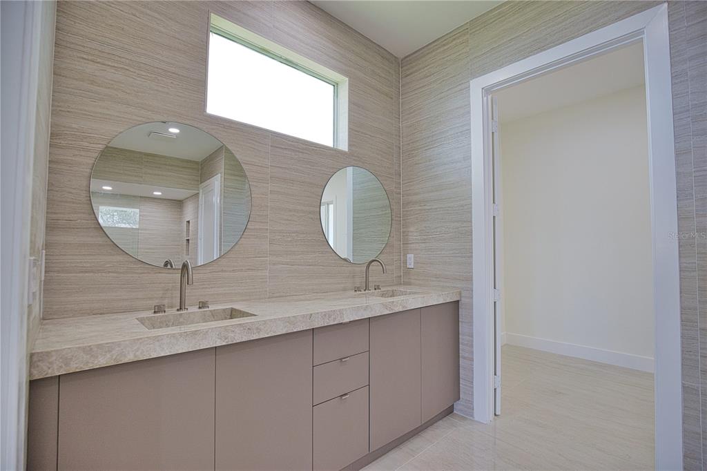 13064 Via Flavia Placida, FL 33946 - Photo 22 of 75 a bathroom with a double vanity sink and a mirror