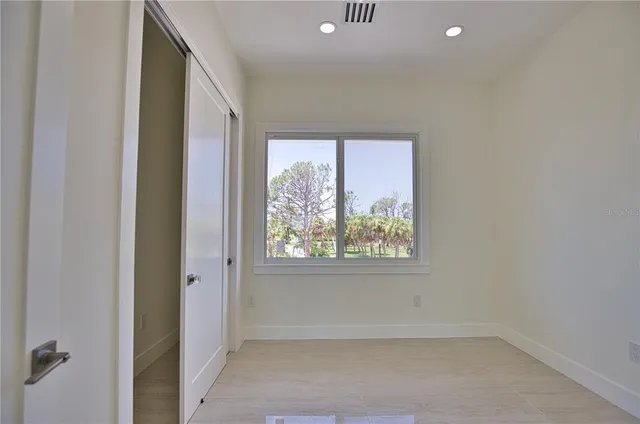 a large kitchen with kitchen island granite countertop a large window