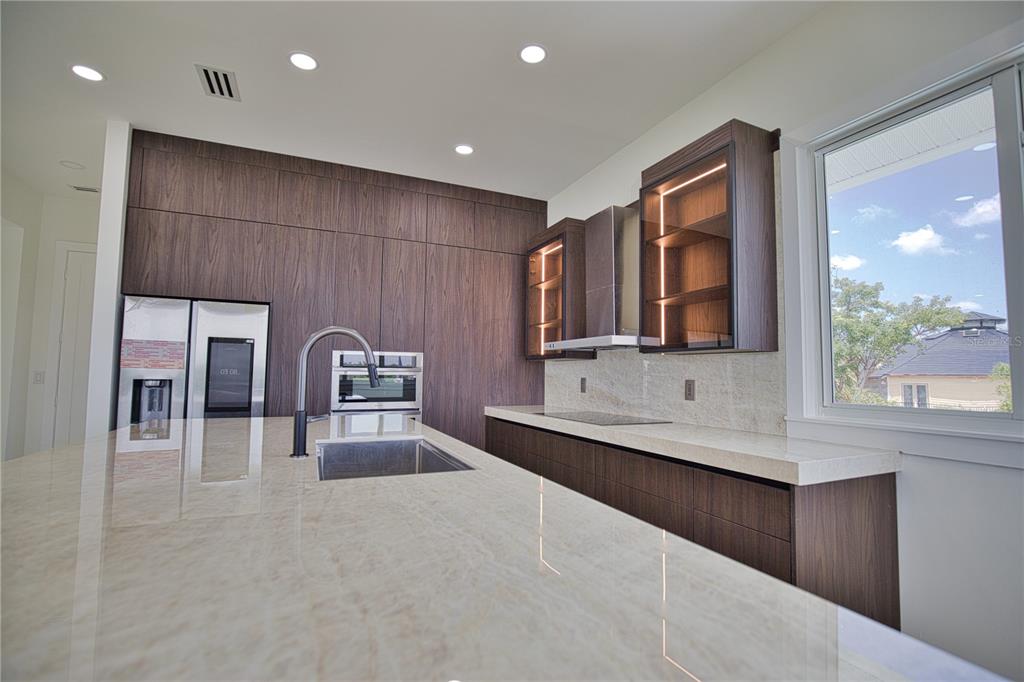 13064 Via Flavia Placida, FL 33946 - Photo 42 of 75 a large kitchen with stainless steel appliances granite countertop a sink and a stove