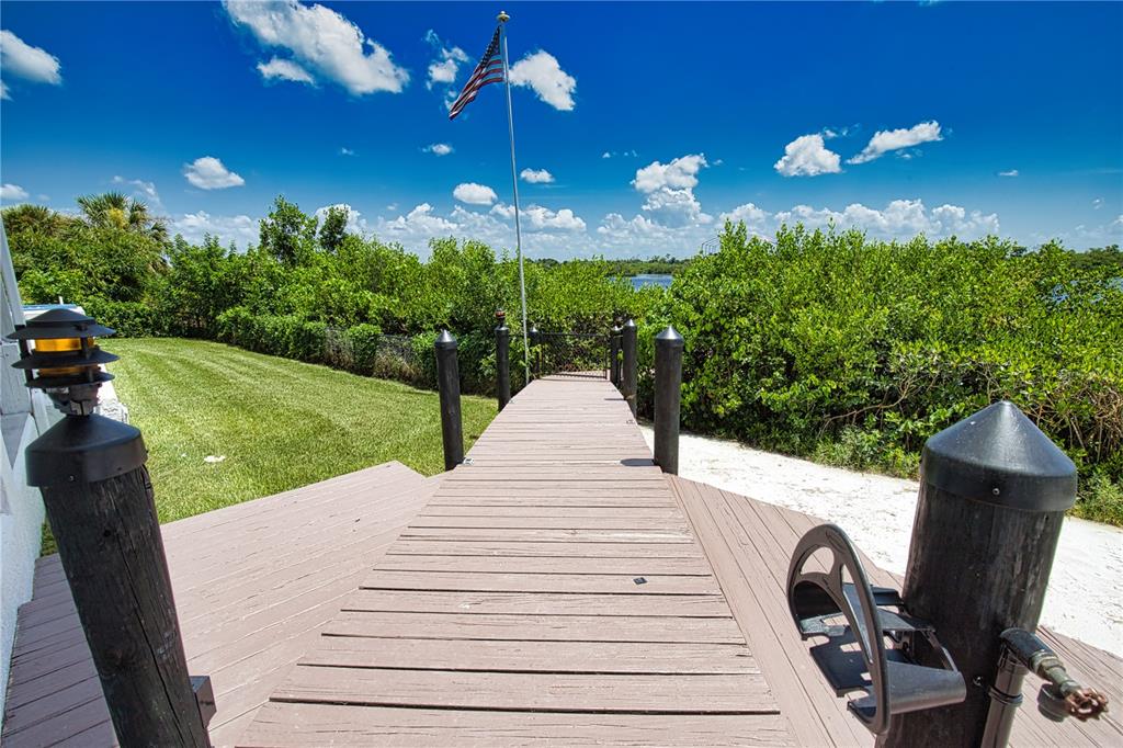 13064 Via Flavia Placida, FL 33946 - Photo 6 of 75 a view of a patio with table and chairs a barbeque with potted plants and big trees