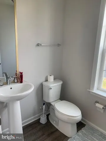a bathroom with a sink toilet and a mirror