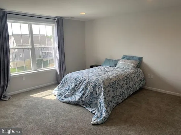 a bed sitting in a bedroom next to a window