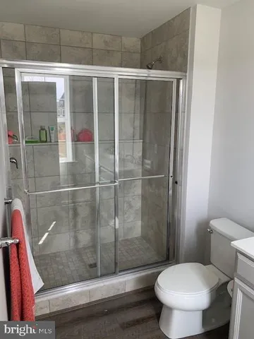 a bathroom with a toilet and a shower