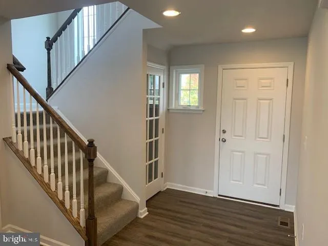 a view of an entryway with wooden floor