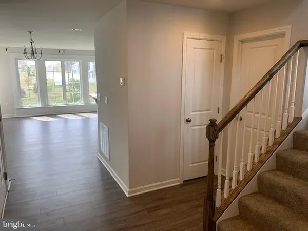 a view of an entryway with wooden floor