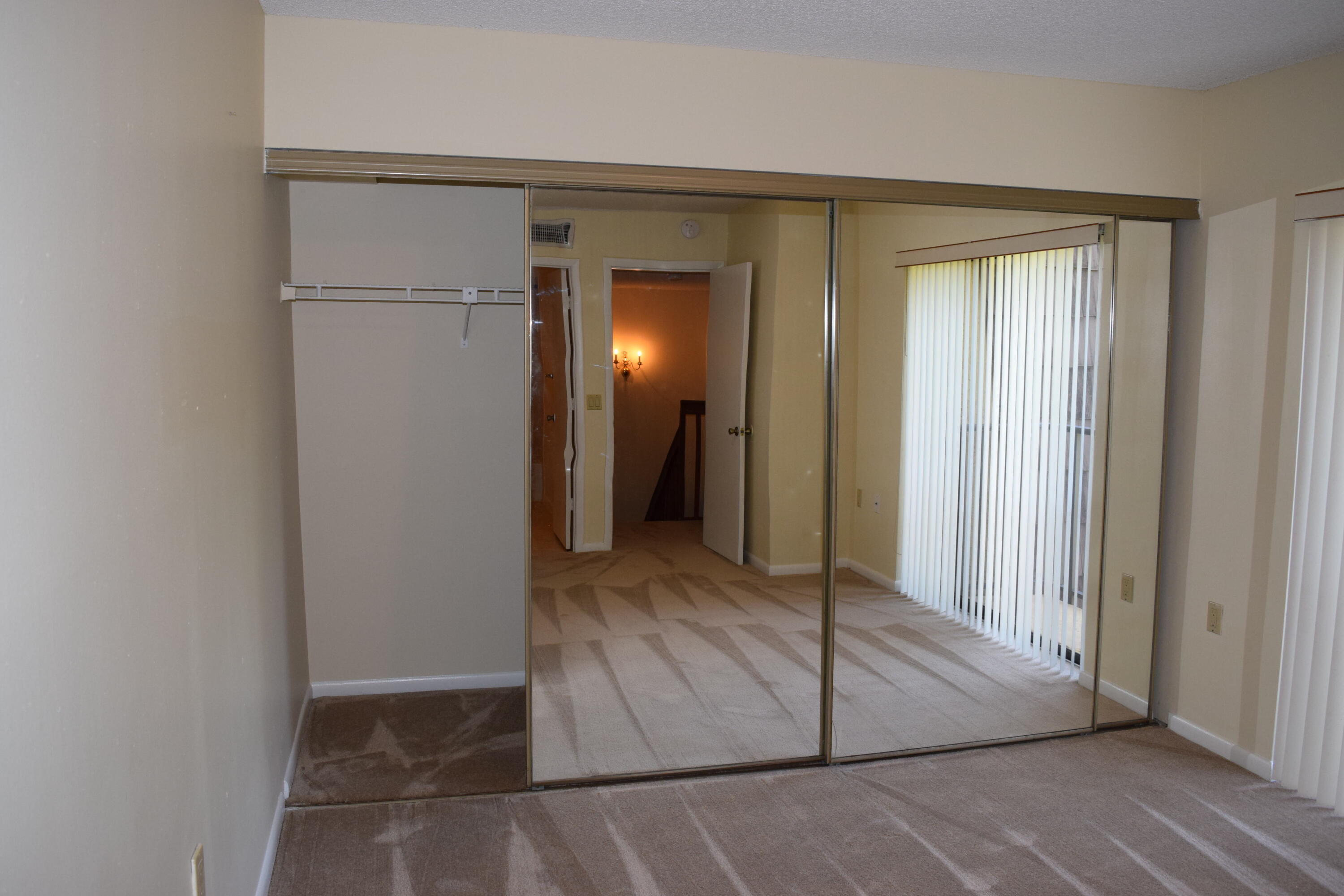 5945 Southeast Windsong Lane, Unit 907 Stuart, FL 34997 - Photo 11 of 34 a view of a hallway with wooden floor
