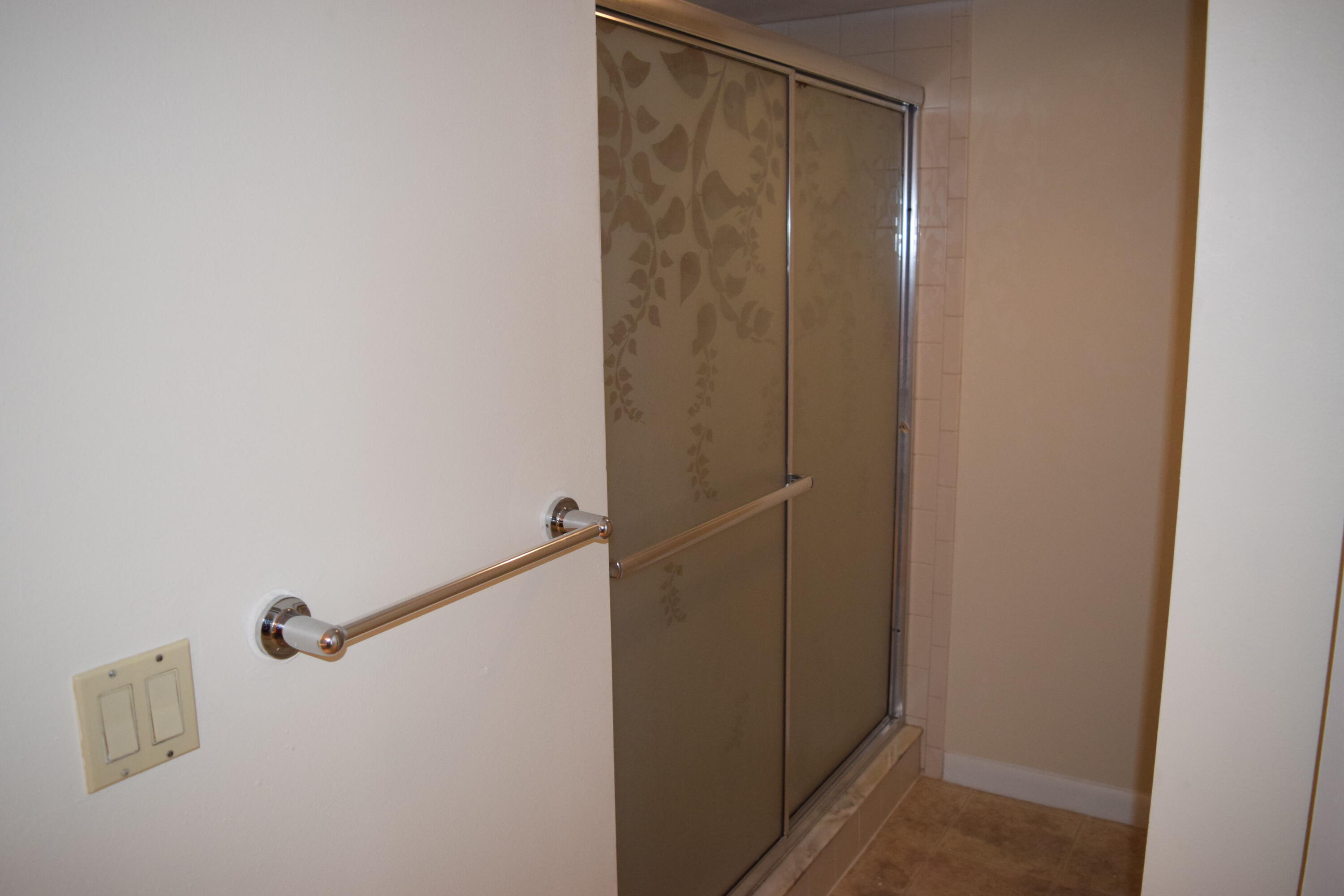 5945 Southeast Windsong Lane, Unit 907 Stuart, FL 34997 - Photo 13 of 34 a bathroom with a shower