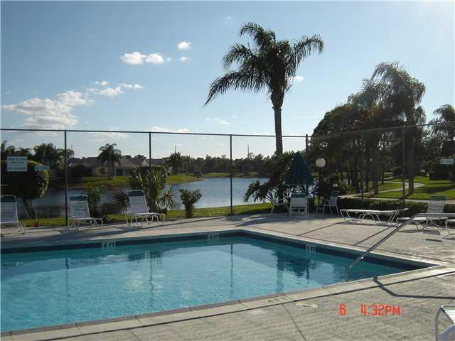 5945 Southeast Windsong Lane, Unit 907 Stuart, FL 34997 - Photo 2 of 34 an outdoor space with furniture