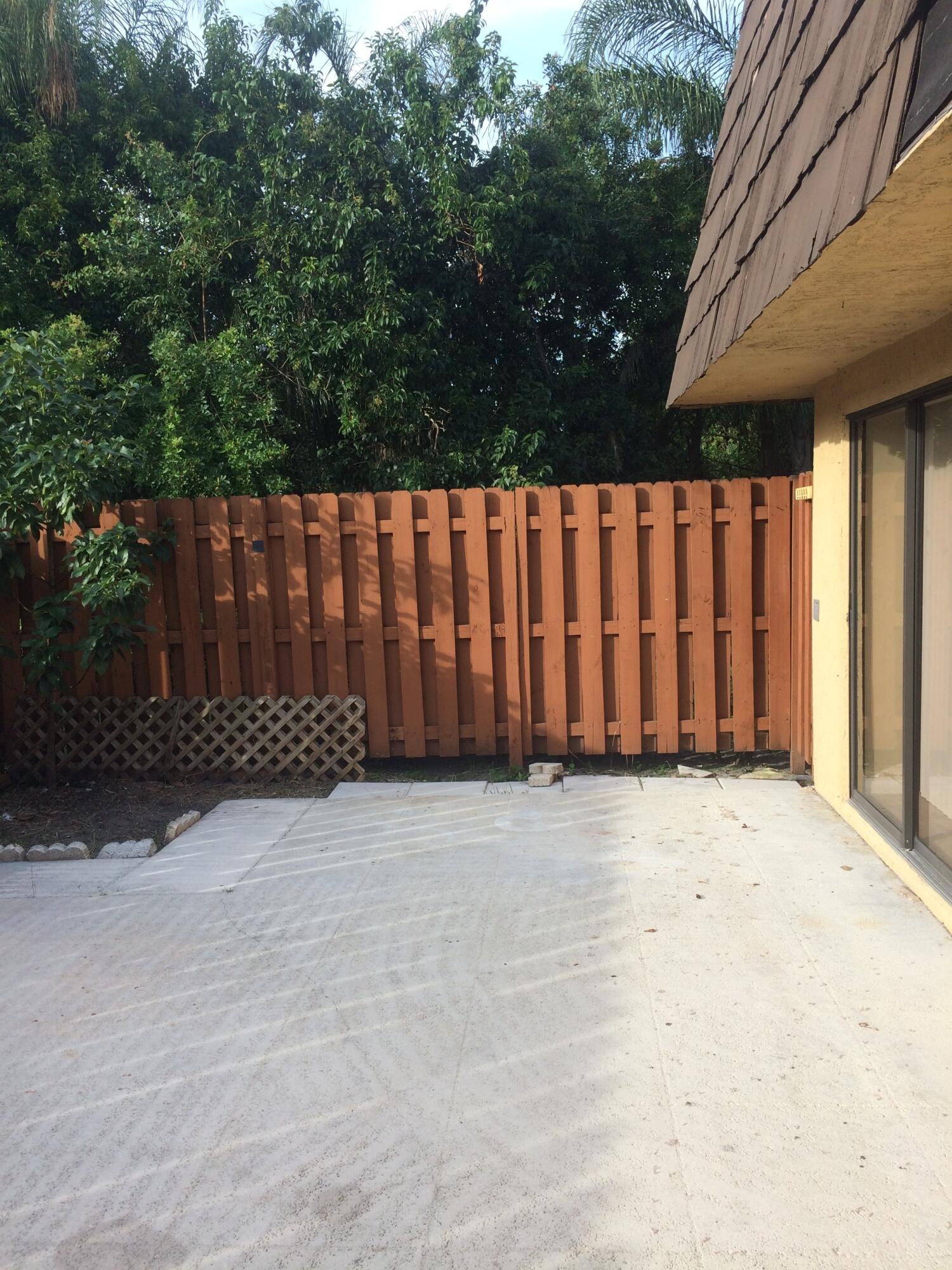 5945 Southeast Windsong Lane, Unit 907 Stuart, FL 34997 - Photo 4 of 34 a front view of a house having yard