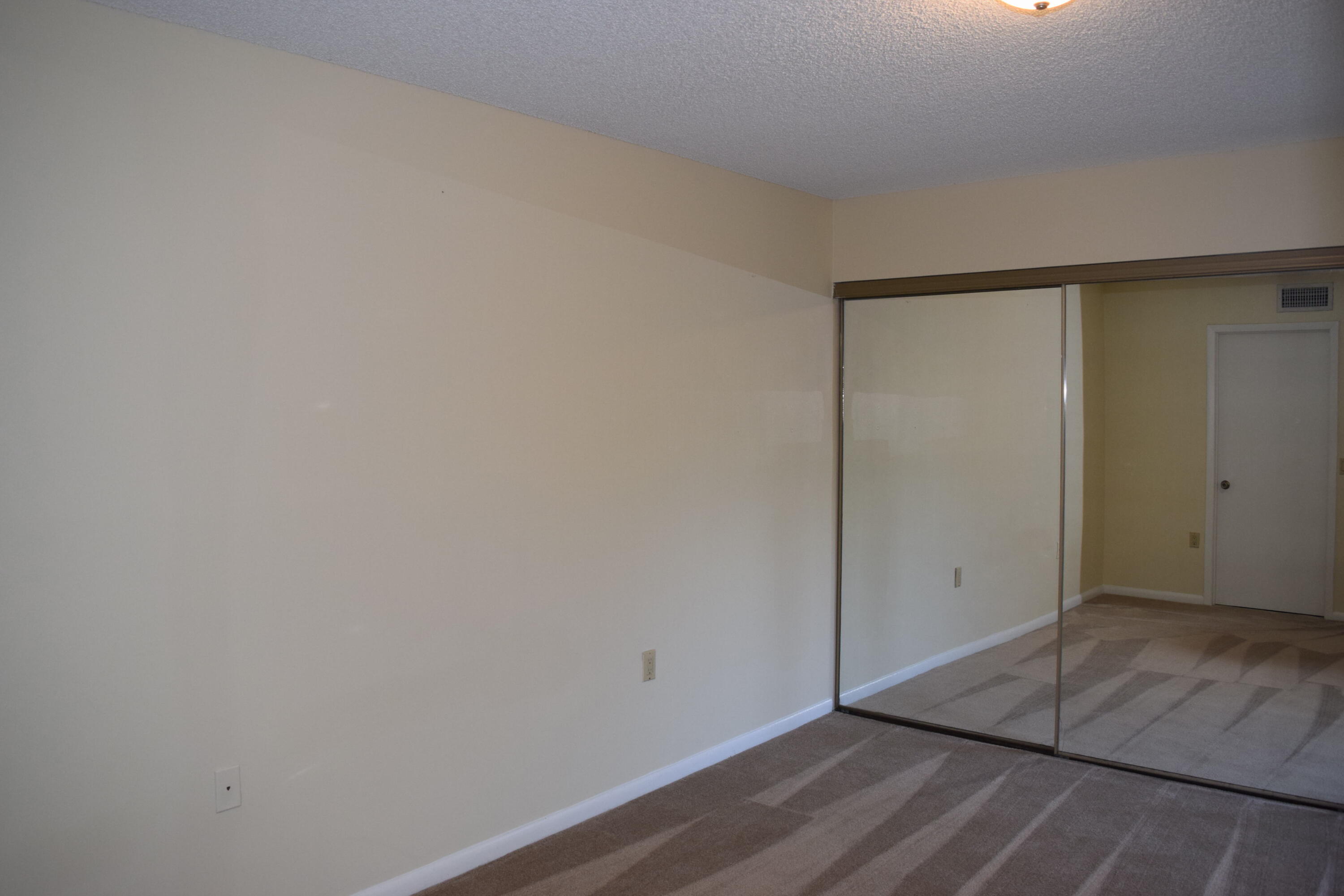 5945 Southeast Windsong Lane, Unit 907 Stuart, FL 34997 - Photo 10 of 34 an empty room with wooden floor