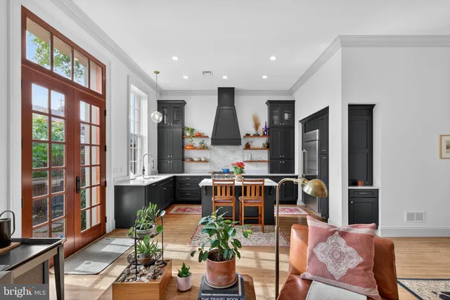a living room with furniture fireplace and large window