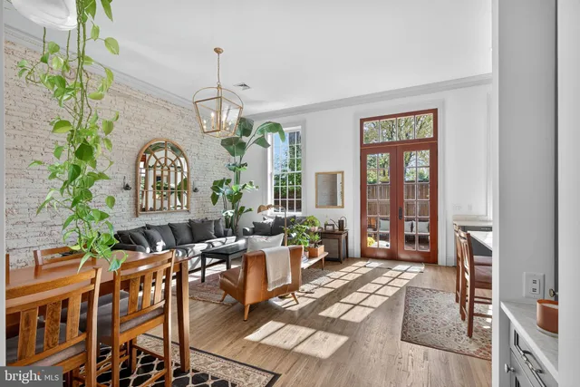 a living room with furniture a fireplace and a chandelier