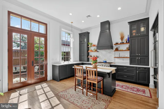 a kitchen with a sink a counter top space and stainless steel appliances