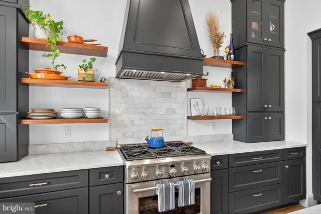 a stove top oven sitting inside of a kitchen