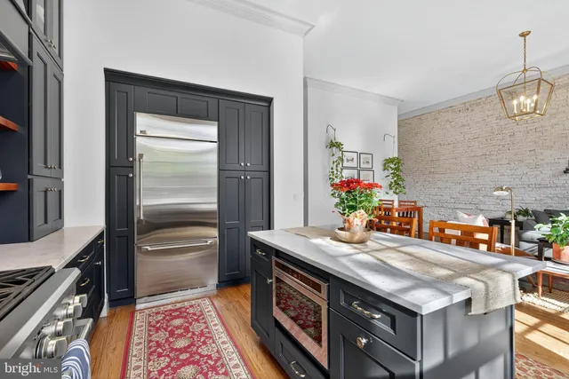 a kitchen with stainless steel appliances granite countertop a sink and a stove
