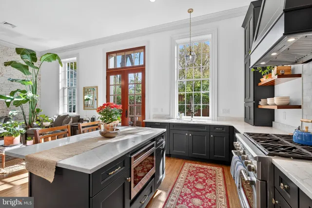 a kitchen with a stove a sink and a refrigerator