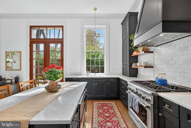 a kitchen with stove and wooden floor