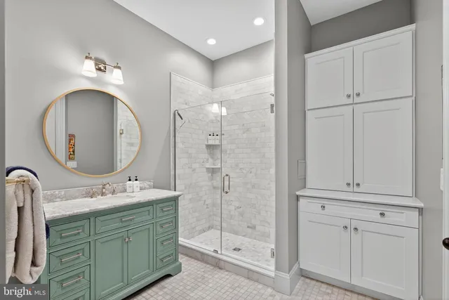 a bathroom with a double vanity sink mirror and shower