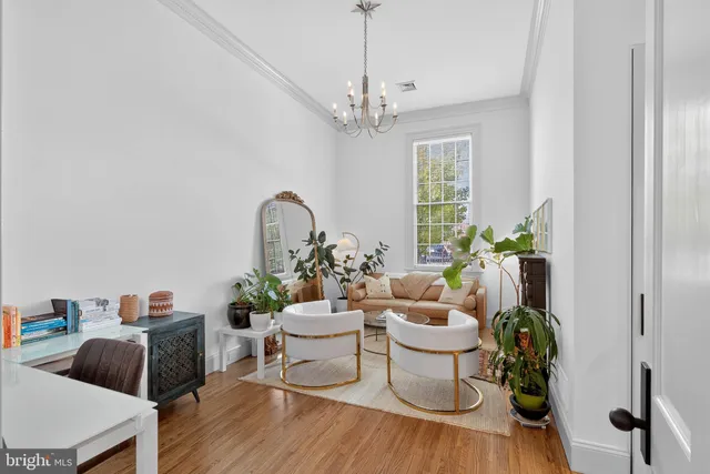 a living room with furniture and a chandelier