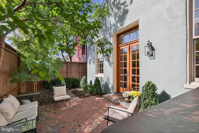 a front view of a house with outdoor seating