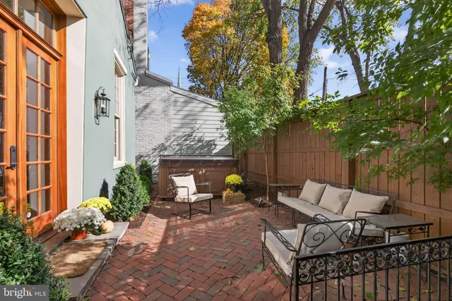 a view of patio with couple of chairs and a fire pit