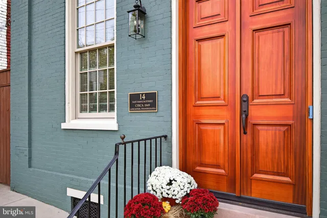 a front view of a house with entryway and wooden floor