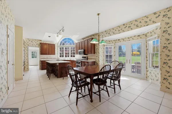 a kitchen with stainless steel appliances a stove a sink dishwasher and a refrigerator