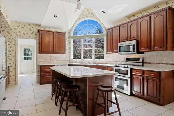 a kitchen with a wooden table and chairs